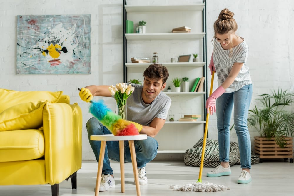 Happy,Man,And,Woman,Doing,Spring,Cleaning,In,Apartment